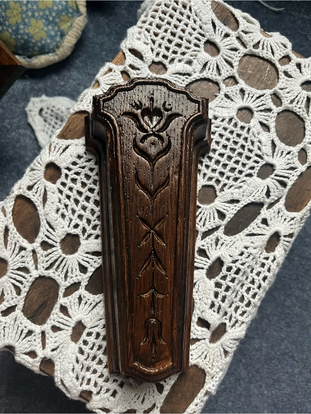 Carved Dark Wood Wall Pocket Vase will include a sprig of greenery