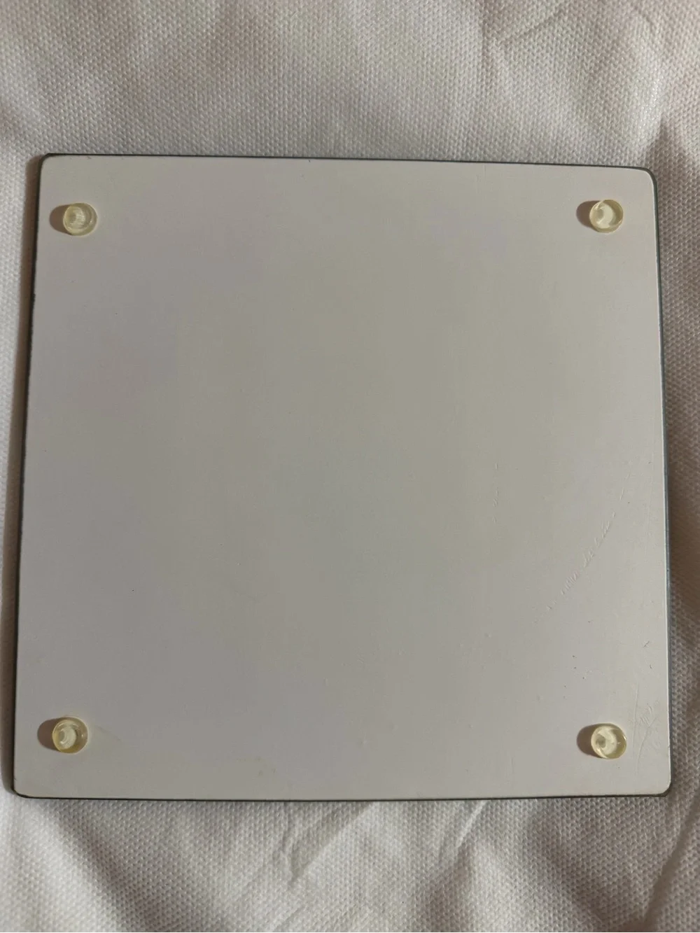 Decorative glass cutting board / trivet with non-slip rubber feet.